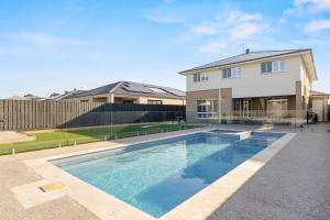 a swimming pool in front of a house at Cowes Market Oasis in Cowes