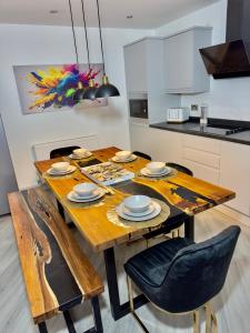 a kitchen with a wooden table and chairs at Clarendon House - Hot Tub in Lincolnshire