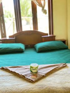 a blanket on a bed with a cup on it at Happy bangalow Don det in Muang Không