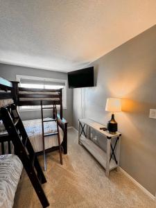 a bedroom with two bunk beds and a table with a lamp at Ultimate St. George Vacation Retreat! in St. George