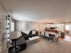 a living room with a couch and a table at Perfect Family Escape - 3 Bed Condo with Pools in St. George