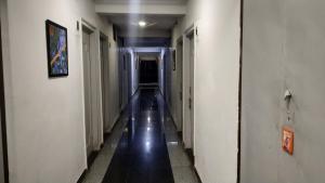 an empty hallway with a long corridor at Hotel Avinash Inn Lodging in Nashik