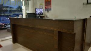 a wooden counter top in a room with at Hotel Avinash Inn Lodging in Nashik