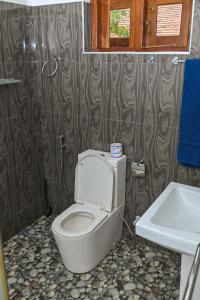 a bathroom with a toilet and a sink at Negombo Royal Villa by Oviniru in Negombo