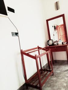 a desk and a chair next to a mirror at Negombo Royal Villa by Oviniru in Negombo