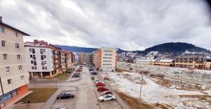 a city with cars parked on a street with buildings at Stan Jovana in Pale