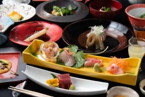 a table topped with plates of food and drinks at Hanare Yado Yoshizumi in Izu