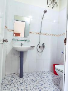 uma casa de banho com um lavatório, um espelho e um WC. em View Nhat Le Beach Hotel em Dong Hoi