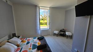 - une chambre avec un lit, une fenêtre et une table dans l'établissement Chambre Les Deux Chênes près de Bergerac, à Le Fleix