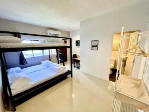 a bedroom with two bunk beds in a room at Lamoon 90s in Hat Yai