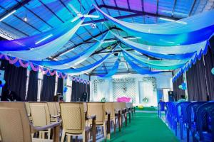 a set up for a wedding with blue drapes and chairs at HOTEL AKSHAYAM GRAND INN in Yelagiri