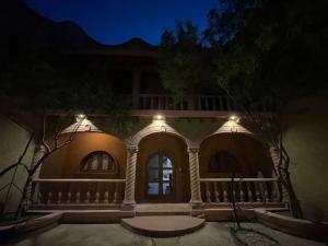 a large house with a porch with lights on it at Casa Orquidea in San Miguel de Allende