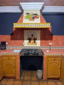 a kitchen with a stove and a counter top at Casa Orquidea in San Miguel de Allende
