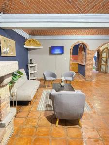 a living room with a couch and a fireplace at Casa Orquidea in San Miguel de Allende