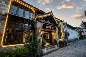 a building with a sign on the side of it at RUI XIANG HE INN - Lijiang Ancient Town in Lijiang