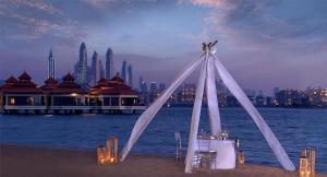 a tent on the beach with a view of a city at Royal Amwaj Apartments, Palm Jumeirah, Free beach and pool access in Dubai