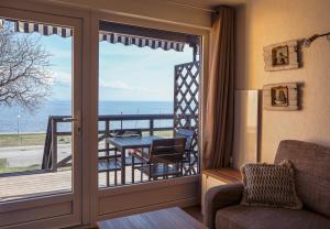 a living room with a view of the ocean at Curonian apartments in Nida