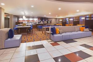 a lobby with couches and a dining room and kitchen at Courtyard Casper in Casper