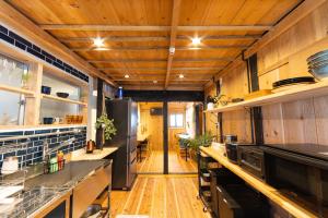 a kitchen with wooden floors and wooden ceilings at Guest House Henza in Henza