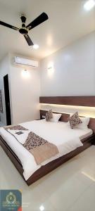a bedroom with a bed with a ceiling fan at Royal Suites in Pune