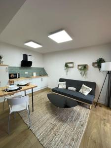 a living room with a couch and a table at Apartamento Casa Cesárea in Cedeira +3 photos