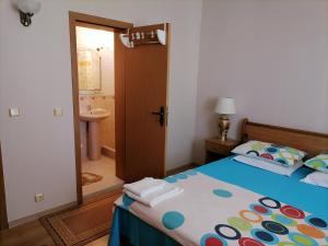 a bedroom with a bed and a bathroom at Guesthouse Olimp in Sozopol