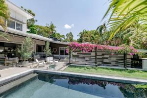 an image of a house with a swimming pool at Villa Ohana Pono Luxury Family Home in Sunshine in Sunshine Beach