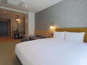Postel nebo postele na pokoji v ubytování HOTEL Tomiya with M's