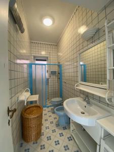 a bathroom with a sink and a toilet at Casa Bella Capri in Capri
