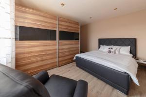 a bedroom with a large bed and a couch at Istrian House La Bora in Koper