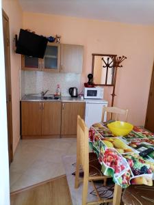 a kitchen with a table with a yellow bowl on it at Guesthouse Olimp in Sozopol