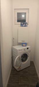 a washer and dryer in a corner of a room at Apartman Cirkic in Sanski most