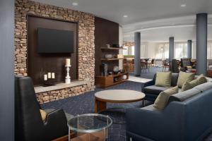 a living room with a couch and a tv at Courtyard by Marriott Panama City in Panama City