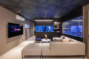 a living room with a couch and a tv at JAPAVISTA Aqua in Osaka
