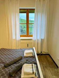 a bedroom with a bed with two towels on it at Glanz und Gloria Weingartenapartment an der Kellerstraße, viele Buschenschänke, sehr ruhige Lage, herrliche Aussicht! in Leutschach