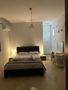 a bedroom with a bed and a desk and a desk at The stone nest in Paphos