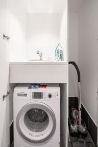 a washing machine in a bathroom with a sink at CBD Riverview 2B1B Apt w Shared Pool, Gym in Brisbane
