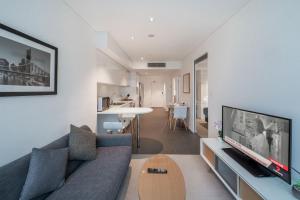 a living room with a couch and a tv at CBD Riverview 2B1B Apt w Shared Pool, Gym in Brisbane