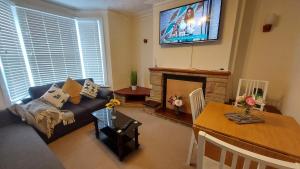 uma sala de estar com um sofá e uma lareira em Rose Villa- Great For Long & Short Stays!!! em Gillingham
