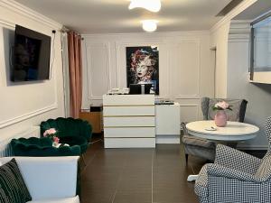 a room with chairs and a table and a painting at Hotel Vandia in Timişoara
