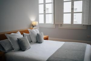 Postel nebo postele na pokoji v ubytování Hotel Boutique Palacio Corredera