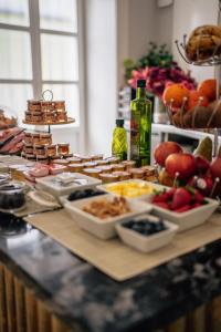 a buffet of food on a table with fruits and vegetables at Hotel Boutique Palacio Corredera in Jerez de la Frontera