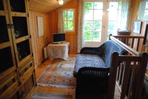 a living room with a couch and a tv on a table at Hotel Villa Antonius in Naantali