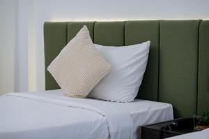 a pair of pillows sitting on top of a bed at Mittapan Hotel in Kanchanaburi