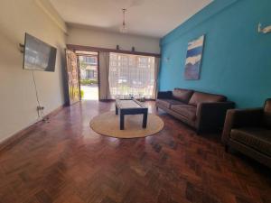 sala de estar con sofá y mesa en Shared Apartment with the best entertainment spots, en Nairobi