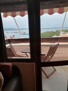 a room with a view of a balcony with a chair at Guesthouse Olimp in Sozopol