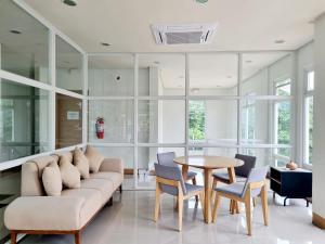 a living room with a couch and a table at 2-Bedroom Condo with FREE Gym, Pool & Parking Access in Puerto Princesa - B2 5Luster in Puerto Princesa City