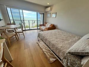 a bedroom with a bed and a table and a balcony at It's all about the views! in Townsville +25 photos