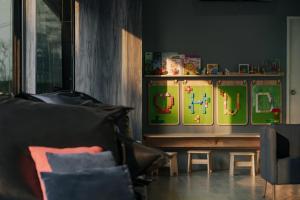 a living room with a couch and a table at Mittapan Hotel in Kanchanaburi +76 photos