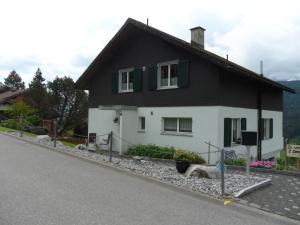 una casa en blanco y negro al lado de una carretera en Wenk Elisabeth, en Wildhaus
